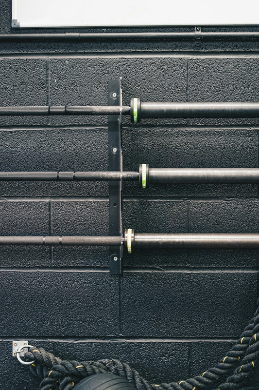 a black wall with metal pipes and a tire