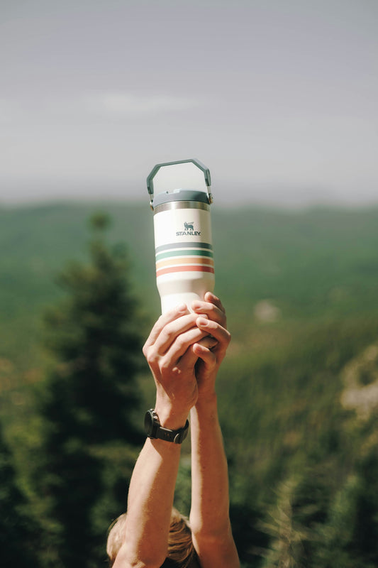 A person holding up a cup in the air