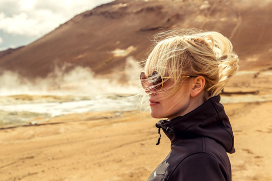 A woman standing on top of a sandy beach