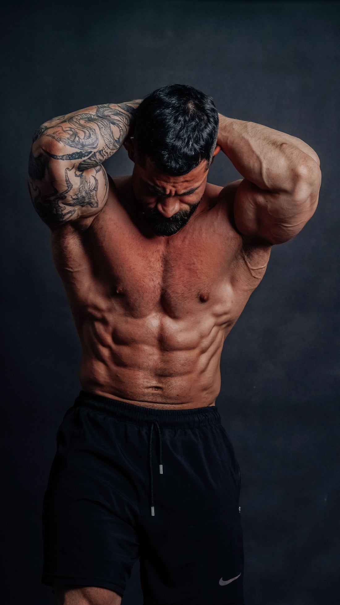 A muscular bodybuilder poses for the camera.